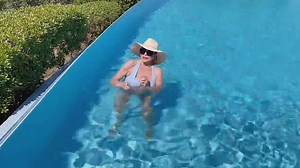 Joan Collins dances in the pool at her St Tropez villa