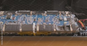 disassembled battery controller. Circuit board, flashing diode. Inspection of inside high-voltage battery. Concept repair, disassembly, technology.