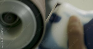 Extreme close up sanding plastic object on machine