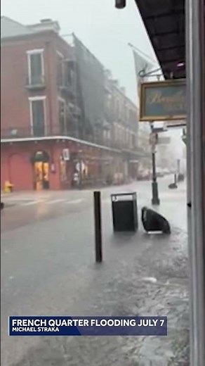 Flood water pushes over sidewalks in New Orleans French Quarter