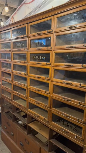 Early 1900s Oak Haberdashery Cabinet 65”W x 18”D x 80”H Built for a time when stores were temples and craftsmanship actually mattered. Original solid oak case. Rows of glass-front, pull out bins. Original gilt lettering still intact, quietly flexing: Blouses. Ties. Gloves. Belts. Boaters. Shawls. Hat Pins. This isn’t “storage.” It’s a full wall moment. A statement piece. The kind of cabinet designers plan rooms around, not the other way around. Perfect for a luxury kitchen pantry, wine or spirit