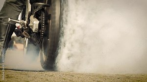 Motorbike burnout, Biker on a motorcycle drifts in smoke, burns tire on a motorcycle.