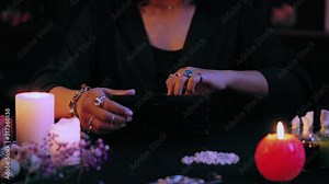 Evil witch taking voodoo doll out of box, preparing for ancient magic ritual