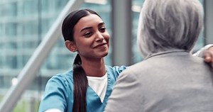 Empathy, hug and doctor with senior patient for support, care and comfort in the hospital Happy, smile and professional young female nurse with an elderly woman after consultation in medical clinic.