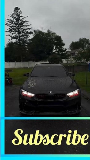 "Matte Black BMW in the Rain"