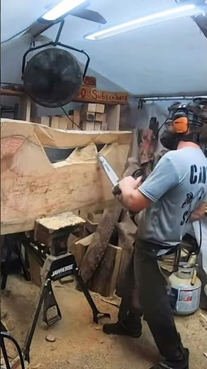 Chainsaw carving a moose by the lake