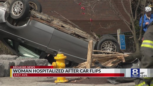 Woman hospitalized after car flips over on East Avenue