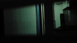 A perverted criminal is peeping into the women's bathroom through the...
