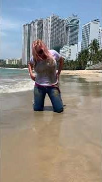 Elena in a white T-shirt without a bra and in blue jeans