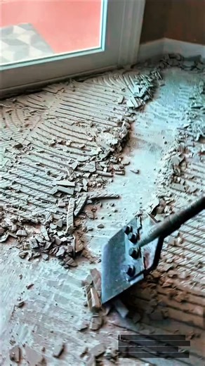 Removing Old Tile Adhesive from Floor Using Heavy-Duty Scraper Tool