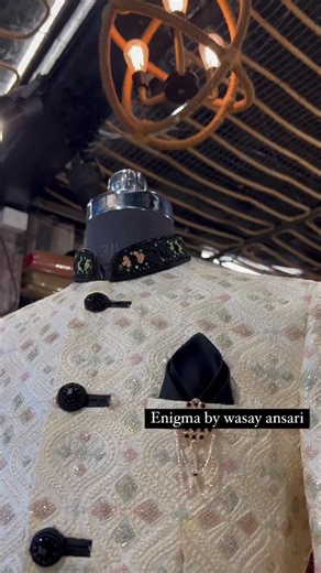 Step into timeless elegance with this handcrafted ivory sherwani — a masterpiece designed for the groom who values tradition, luxury, and individuality. The intricate jacquard weaving, subtle pastel motifs, and contrasting black accents create a perfect balance of sophistication and modern charm. Finished with a statement collar, designer buttons, and a classy brooch, this piece reflects pure regal energy. Whether it’s your engagement, reception, or a signature photoshoot look, this sherwani ens