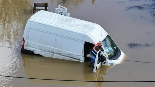 Firefighters rescue driver stuck in flood water