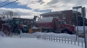 Massey Ferguson 8S.305 with front mount snowblower loading trucks | John Hiebert