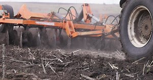 Slow motion Tractor Plowing Field Tillage Agricultural land Farm Agriculture Preparing the soil for sowing. Plow Machine Equipment Working Rural Season