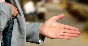 Close up of men hand rub procedure by using alcohol sanitizer. Good example to show the importance of hand hygiene during Covid - 19 pandemic. Coronavirus.