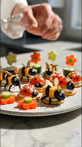 GARDEN CRITTER SNACK BOARD (BEE LADYBUG EDITION) This is the kind of snack plate that makes people stop mid-scroll and say: “WAIT… you MADE that?!” These little crackers look like a tiny garden party—bees, ladybugs, and flower bites—all cute enough for kids, but classy enough for guests. What you need: Crackers • cheese cubes (cheddar or gouda) • black olives • cherry tomatoes • cucumber • red bell pepper (or tomato slices) • chives/green onion • toothpicks • a little cream cheese (optional, to 