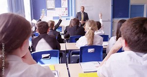 4k, Two students passing notes during a class.