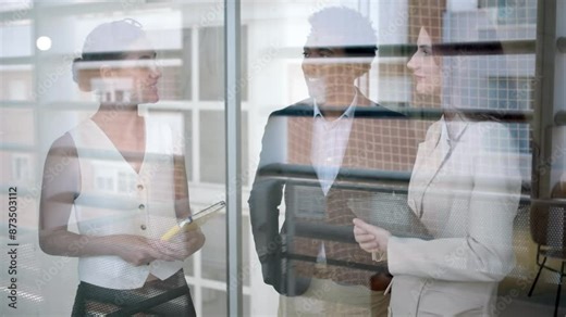 In a contemporary office, professionals collaborate, share ideas, and demonstrate teamwork and inclusivity. The setting reflects a modern workplace with diverse employees working together