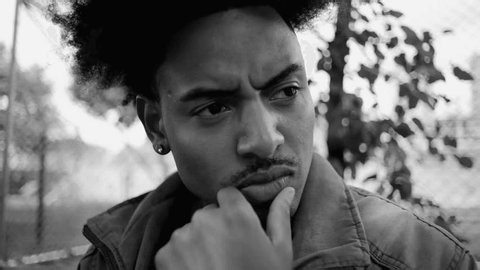 clip-3992022957-young-man-african-descent-close-up-thoughtful-expression