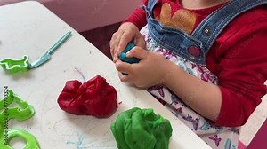 Little kids playing with play dough. Child development. Sensory development and experiences, themed activities with children, fine motor skills development