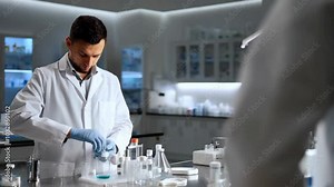 Pharmaceutical lab technician preparing a new medication formula under sterile conditions.