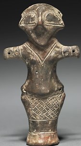 At least 6000 years old, this figure is attributed to the Vinča culture of Neolithic Serbia. It is made of fired clay with traces of red paint and features a stylized anthropomorphic form with a protruding belly, large eyes, pointed chin and nose, and multiple perforations at the temples, hands, and hips. The figure measures 9.5 cm (3 3/4 in) in height and is remarkably well preserved. This artifact is now housed at the Cleveland Museum of Art in Cleveland, Ohio, United States. It was gifted by 