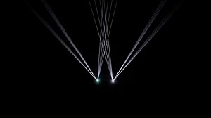 Download High speed laser light show on black background with flashing blue and green laser beams. This music performance nightlife background animation is full HD and a seamless loop. for free