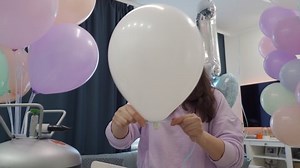 Woman using helium tank blowing up balloons to decorate home for party, colorful balloons for birthday wedding christmas party event decorations. High quality 4k footage