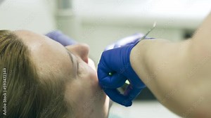 The dentist places a temporary filling on the tooth. Dental treatment.