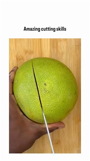 The Cinex Community on Instagram: "The post features a 12-second video showcasing expert knife work on a green pomelo, where the fruit’s thick rind is carved into a precise, symmetrical star pattern before the juicy, pink interior is revealed. The reel frames the process as both culinary skill and visual art: the clean cuts, controlled hand movements, and final peel-back create a satisfyingly crisp transformation that appeals to fans of food crafting and ASMR-style content. The contrast between 