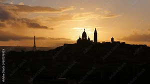 Timelapse. Sunset in Paris, France. Filmed from the north of the city. The sun is setting behind the sacred heart. Great contrast and yellow colors in the sky.