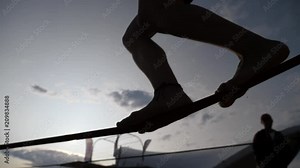 Young girl legs silhouette walking balancing on slackline rope the modern sport activity