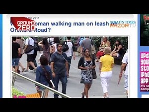 Woman walks man on a leash