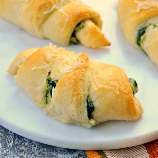 These spinach artichoke crescent rolls are the perfect appetizer or stuffed bread option! Everyone will rave about them. Recipe--> https://www.mysuburbankitchen.com/spinach-artichoke-crescent-rolls-an-immaculate-holiday-appetizer/ | My Suburban Kitchen