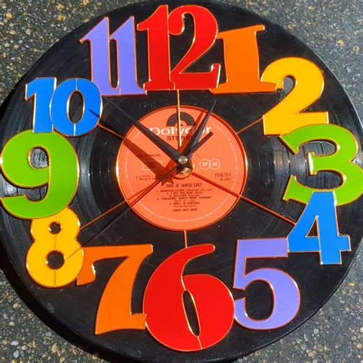 We all have an old album lying around. Make it into a brightly colored clock with a little bit of resin. #resinart #resin #clock #clockart What colors will you do yours? | Pour Away Fluid Arts