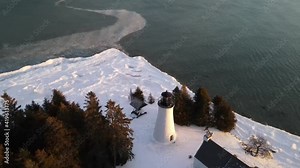 Old Presque Isle Lighthouse in Michigan during the winter with a sunset. Stock Video