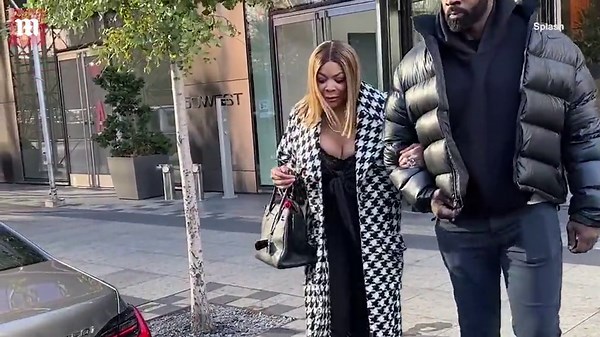 Wendy Williams heads to photoshoot in checkered trench coat and plunging dress