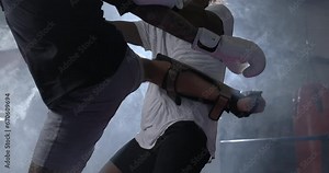 Rivals Engaged in Intense Duel, Two Fighters Face-Off in Ultra Slow-Motion Inside Boxing Ring exchanging kicks and blows Stock Video