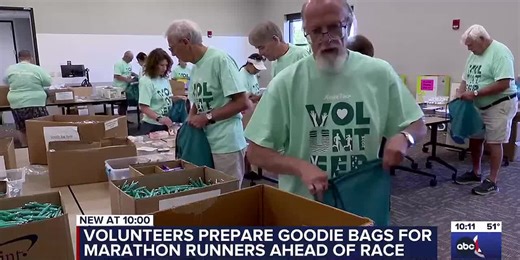 Volunteers prepare goodie bags for marathon runners ahead of race