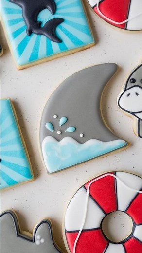 Shark fin cookie decorated with royal icing for Shark Week #cookiedecorating #royalicing #sharkweek
