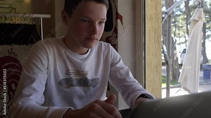 study during the holidays-concentrated boy writes a thesis on the computer