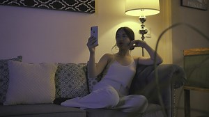 Woman resting on a sofa while talking on video call - Free Stock Video