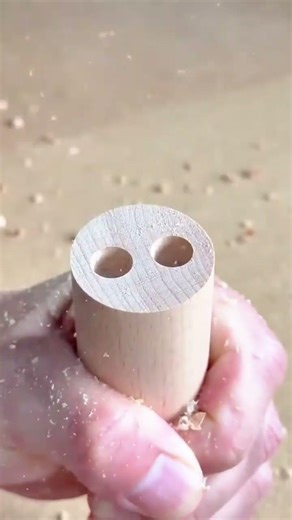 drilling precise holes into a small cylindrical wood block using a power drill machine for carpentry