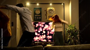 Four friends dancing and having fun together at home