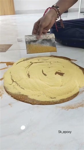 Mixing clear epoxy resin with gold glitter or pigment powder
