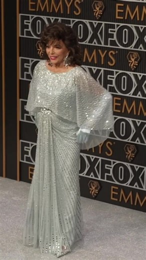 Joan Collins Shines at Awards Show in Icy Blue Gown