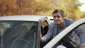 Man pushing a car with empty gas tank