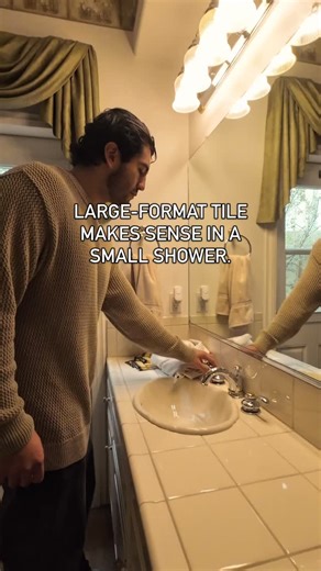 The shower uses 24”x48” porcelain wall tile paired with a linear tile-in drain, creating a clean, uninterrupted surface from floor to ceiling. Benefits of this approach: – Fewer grout joints – Easier cleaning over time – A more unified wall plane – Better water management at the floor The niche is integrated directly into the tile layout so storage doesn’t interrupt the overall composition. Design: @5s_designstudio Build: @5blox_inc Location: Los Alamitos • Sink: Signature Hardware Myers 21” Rec