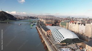 Aerial shot panning over the Balna Cultural Centre and across The Danube, a beautiful river running through Budapest, Hungary.