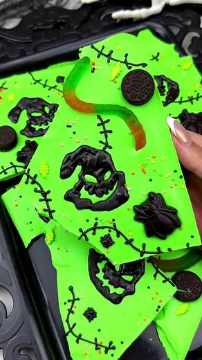 Another NBC bark with Oogie Boogie chocolate transfers. See my Zero bark to see how I make the chocolate transfers. I added mini Oreos, gummy worms, and these cute gummy sweet tooth fairy spiders I found at Michaels StoresI used Stover's Confection Connection sweet shop vanilla melting wafers and colored them with green candy color and a bit of rolkem neon green color from Sugary Essentials . The transfers were made using Stover & Company sweet shoppe dark chocolate melting wafers with black can